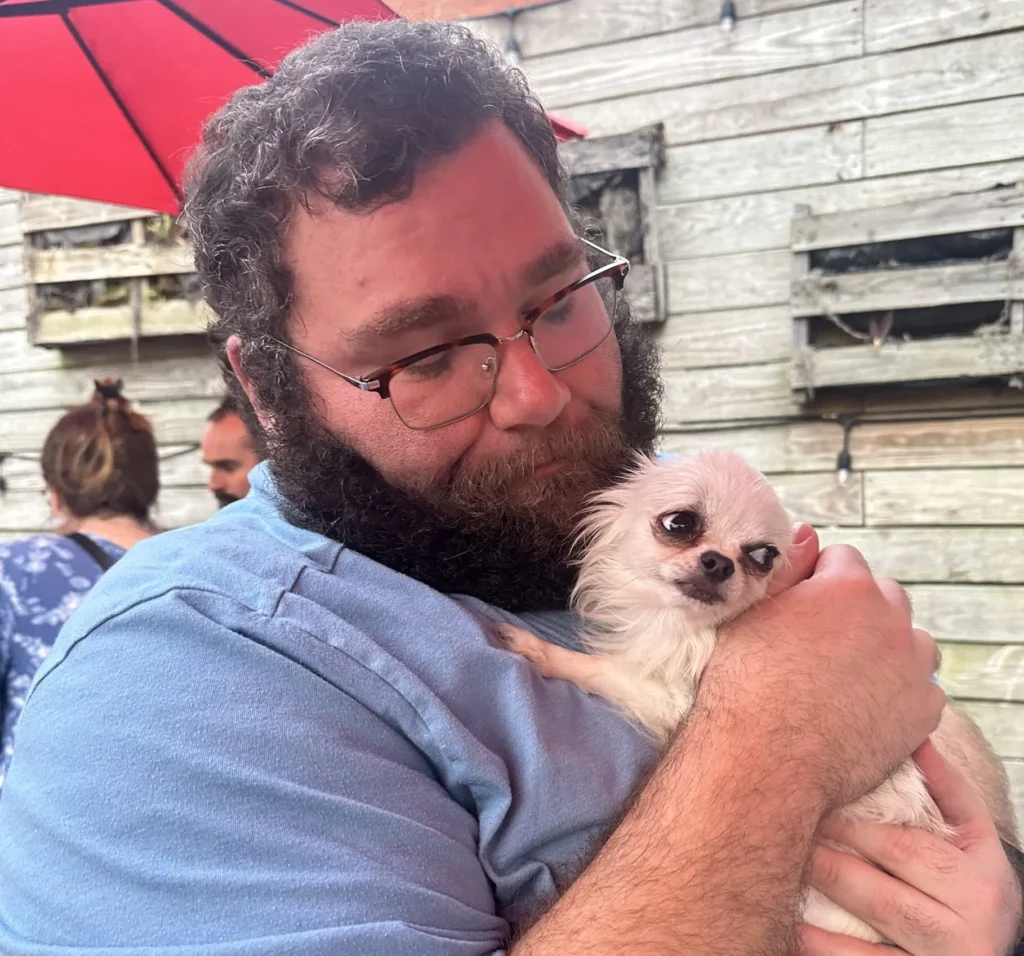 Gabe from Cabin Companions escorting a dog as her flight nanny.
