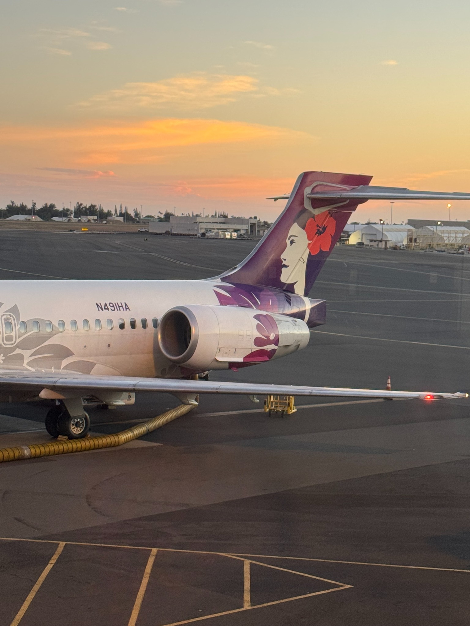 Hawaiian Airlines aircraft at sunset during Mimi’s escorted journey from Honolulu