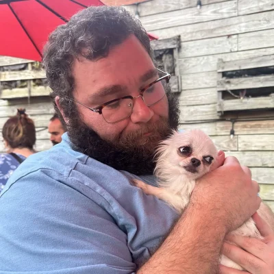 Gabe Downey escorting a dog during a Cabin Companions journey